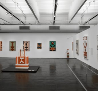 A gallery room displaying multiple paintings